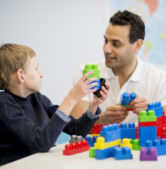 caregiver playing with a child with special needs