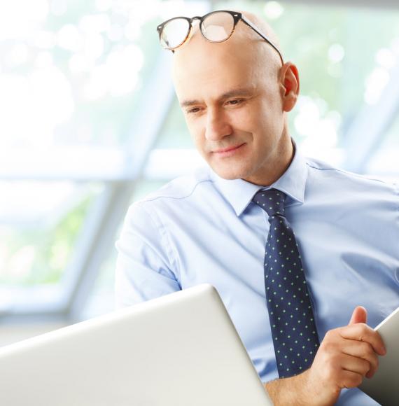 A CIO studying a computer