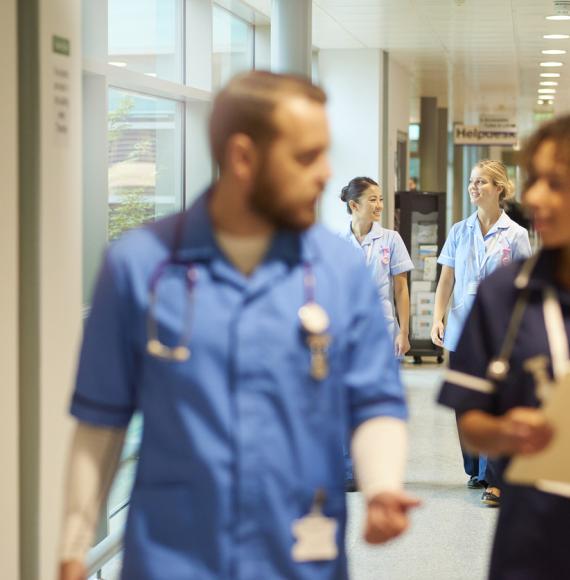 NHS nurses walking down a corridor