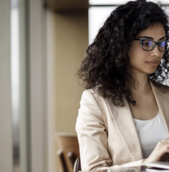 Photo of a woman working at a computer