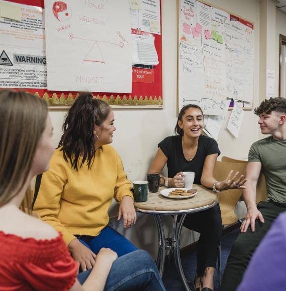 Group of young people sat together talking