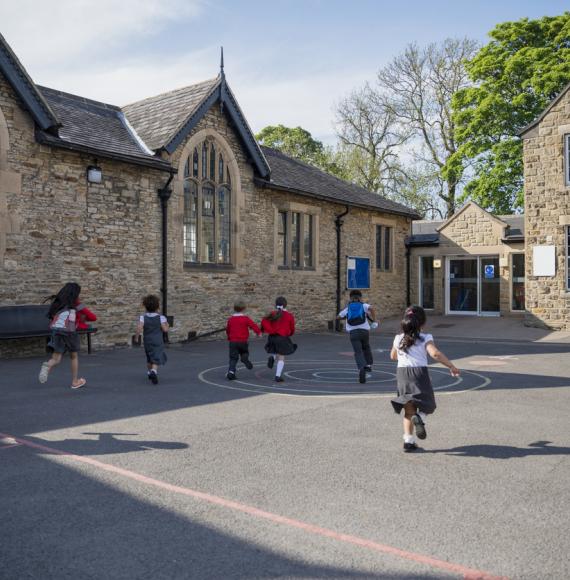 Children running through a playground of a primary school