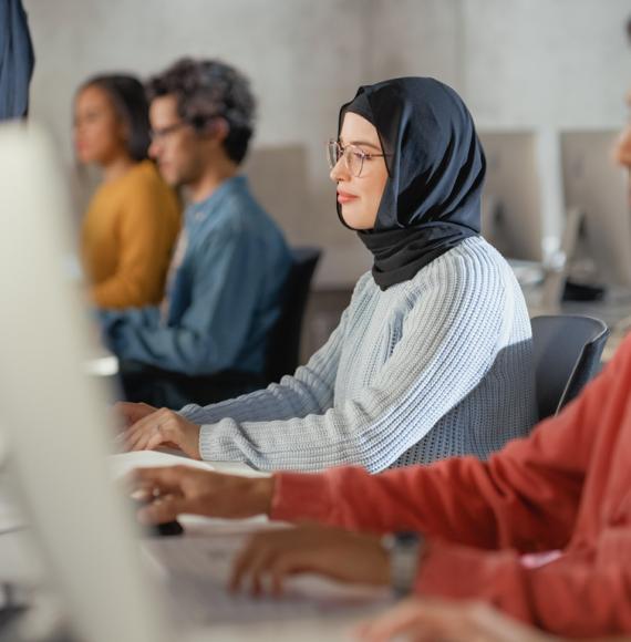 Adult learners working at computer