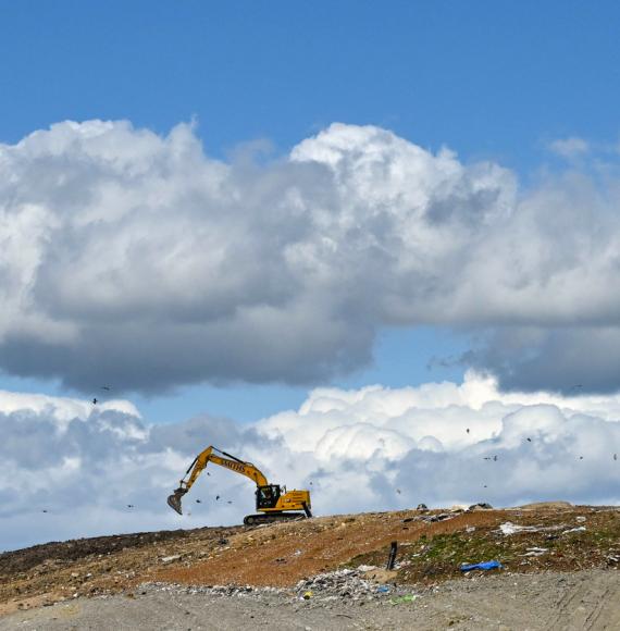 A digger on a landfill site