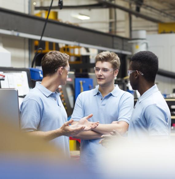 Three male apprentices discussing something