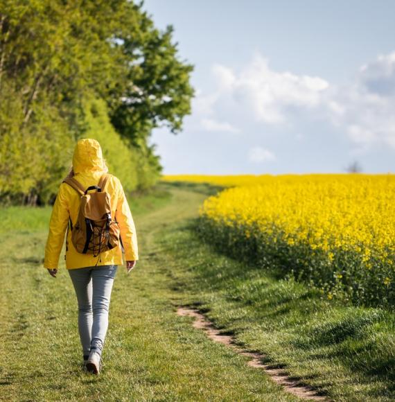 Woman walking in a field of flowers