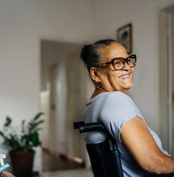 A woman in a wheelchair smiles