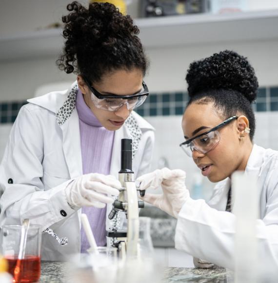 Teenage student using the microscope in the laboratory