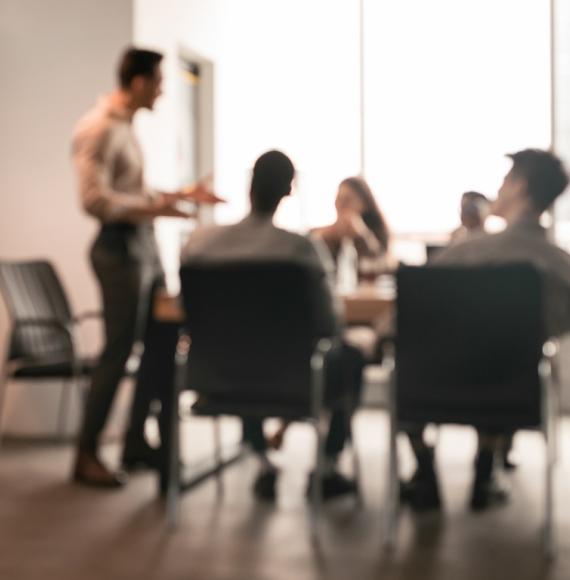 People gathered round a desk in an office space