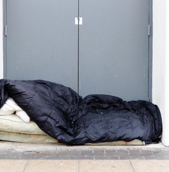 Man sleeping rough in a doorway