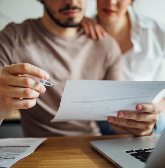 Couple managing bills with a computer