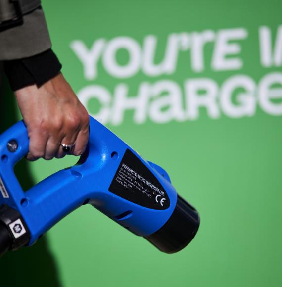 Woman holding an electric vehicle charger