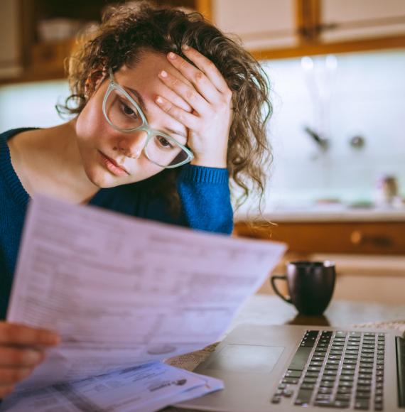 Young woman looking upset at her bill