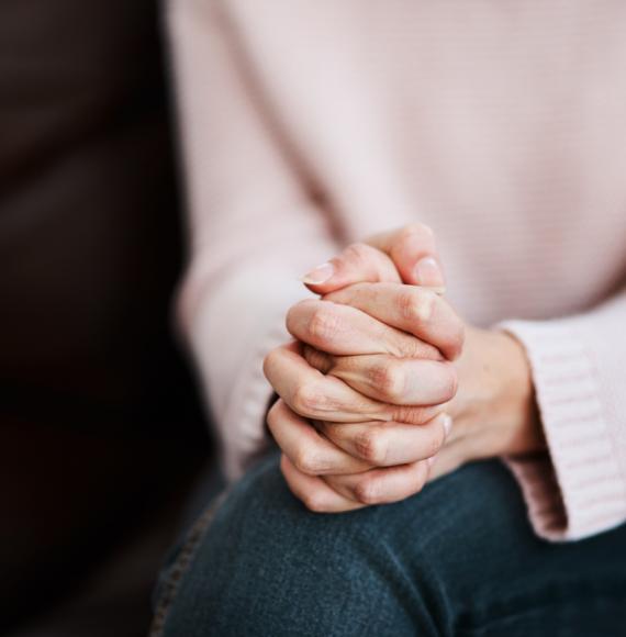 Cropped shot of a woman sitting on a sofa and feeling anxious