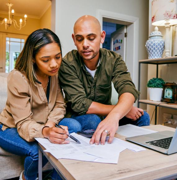 A couple looking through budgeting and bills