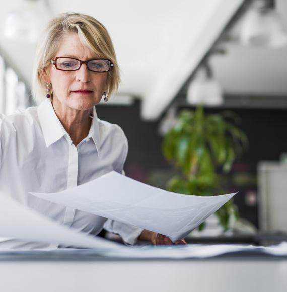 woman looking at sheets of paper