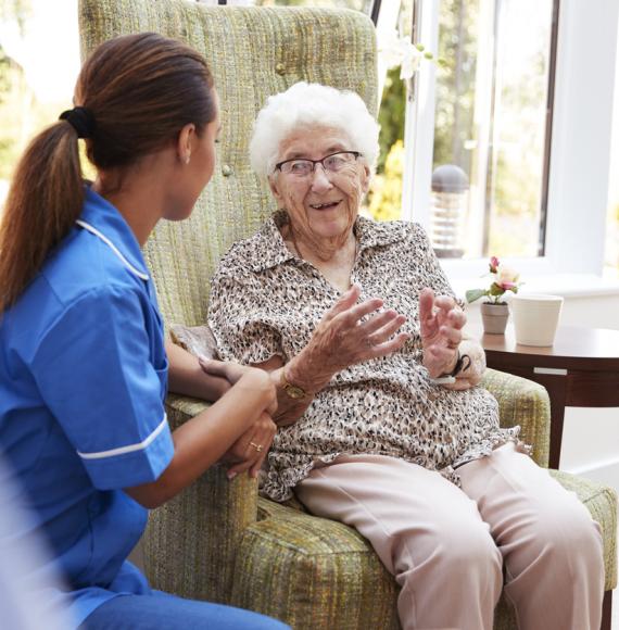 Elderly lady sat with carer