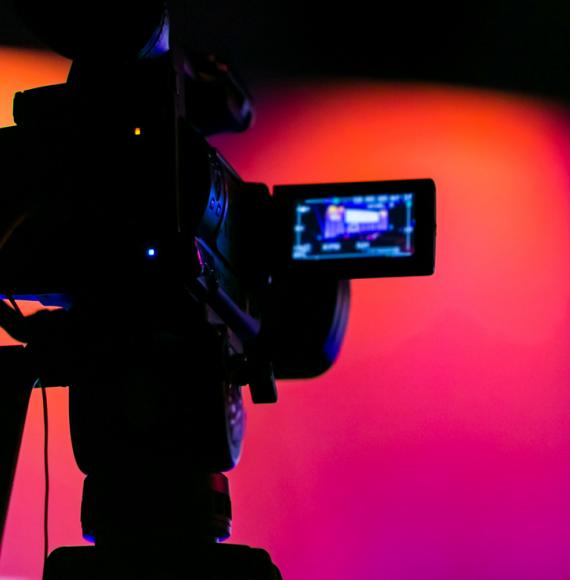 Silhouette of a camera filming