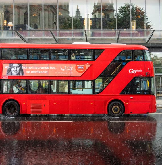 Side view of a london bus in the rain