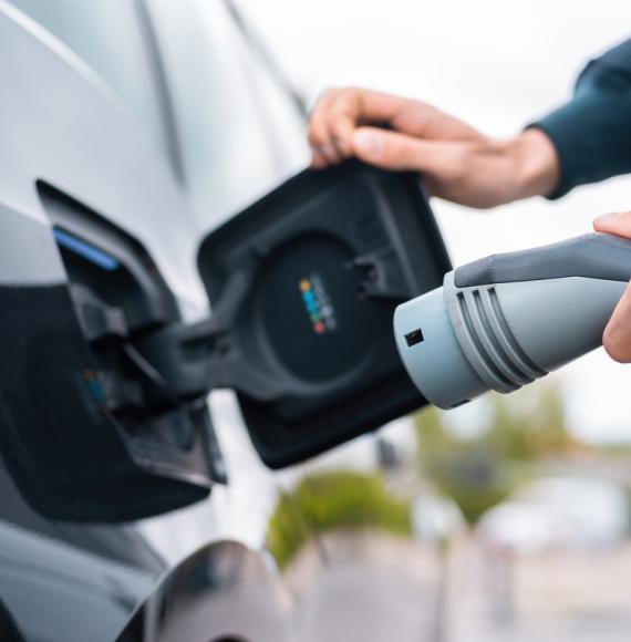 Man using electric vehicle charger