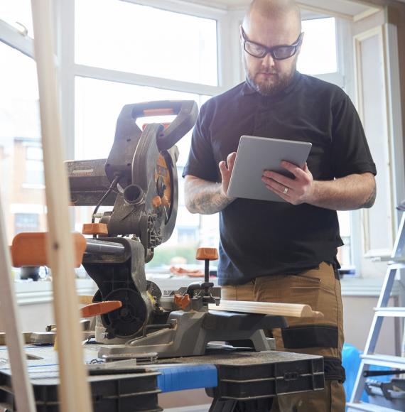 Self-employed person working on a tablet. Tradesman.