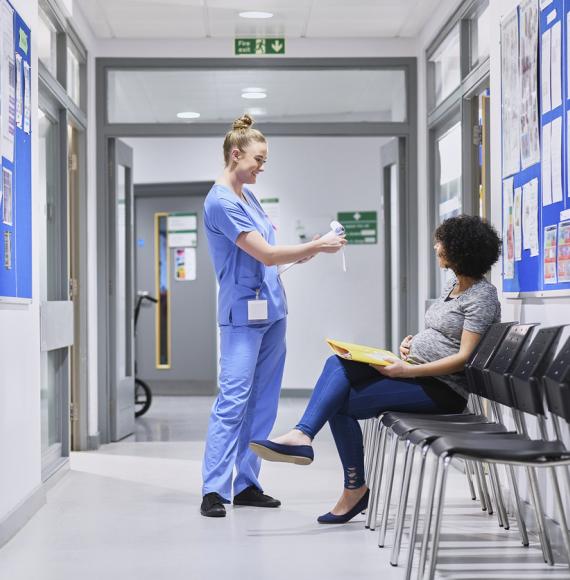 NHS nurse talking to a pregnant patient