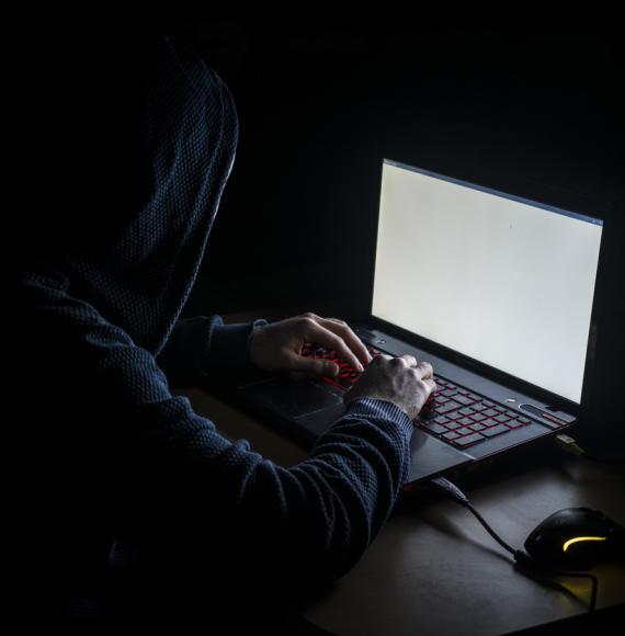 A hacker using a laptop