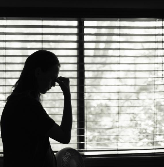 Silhouette of woman looking sad