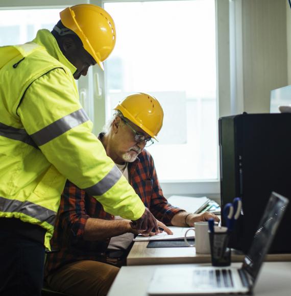 Two engineers working through plans
