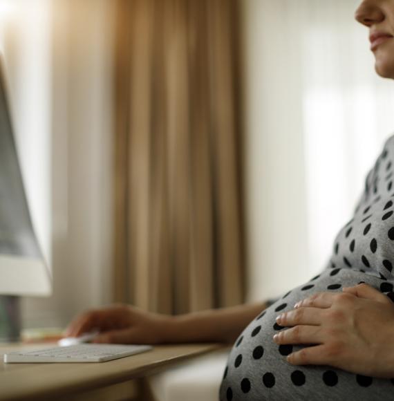 Pregnant woman working on computer