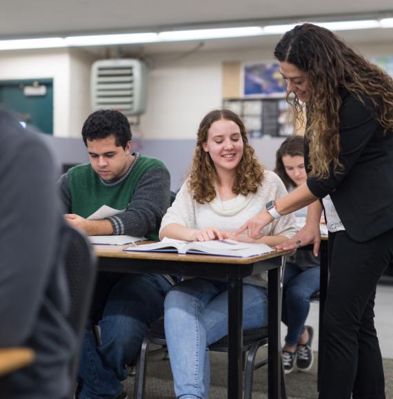 Teacher talks to older students 