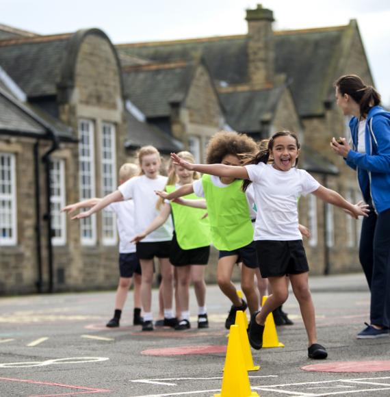 Children doing physical education in a school playground