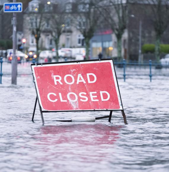 Road closed sign in a flooded street