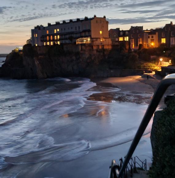 Sunset view of houses at the top of cliffs in Tenby