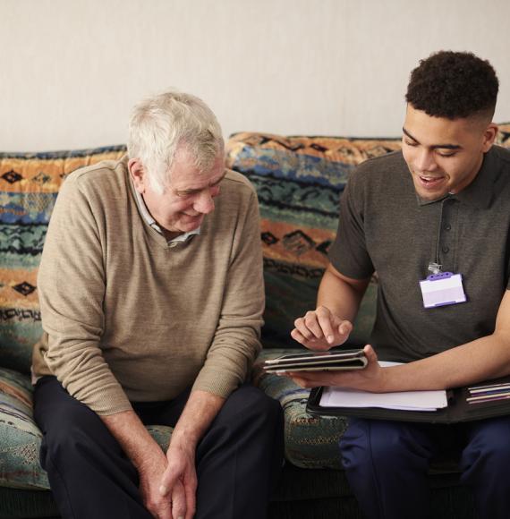 Carer using an iPad with a patient