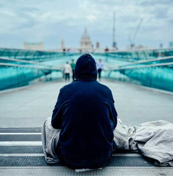 Homeless man in London with St Paul's Cathedral in the background
