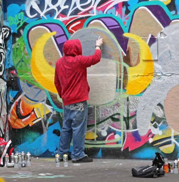 Man spray painting a well