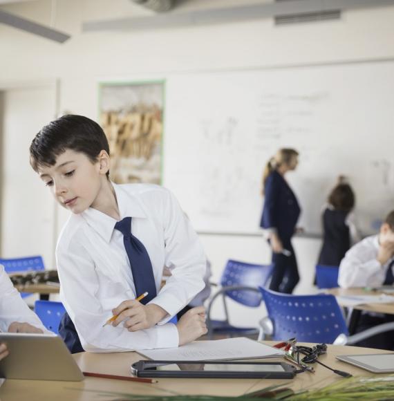 Two schoolchildren using an iPad