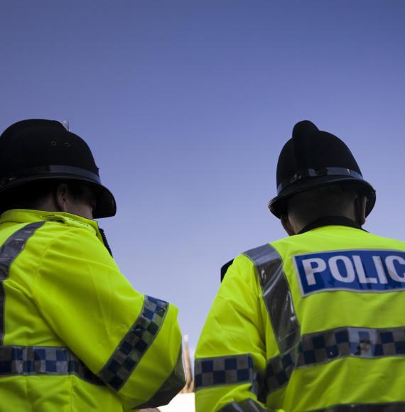 Police officers from below. Blue skies