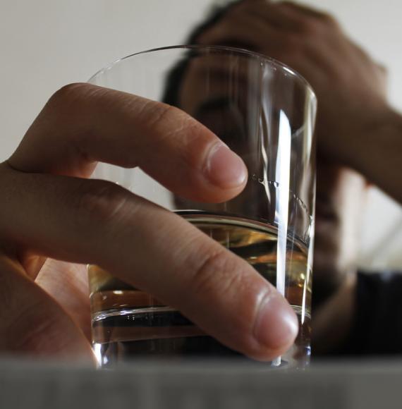 Man holding class of alcohol