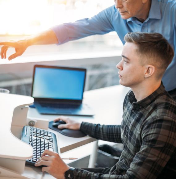 Young man on work experience at a computer