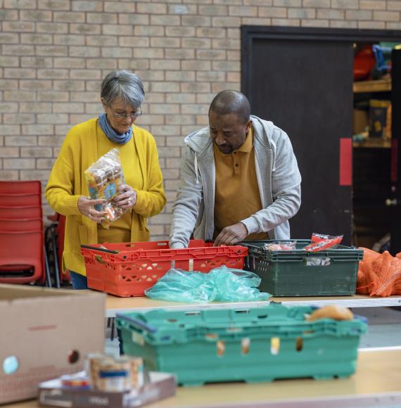 Woman and a man setting up a food bank in the North of England