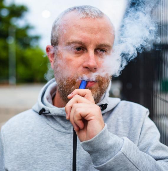 Man using a disposable vape