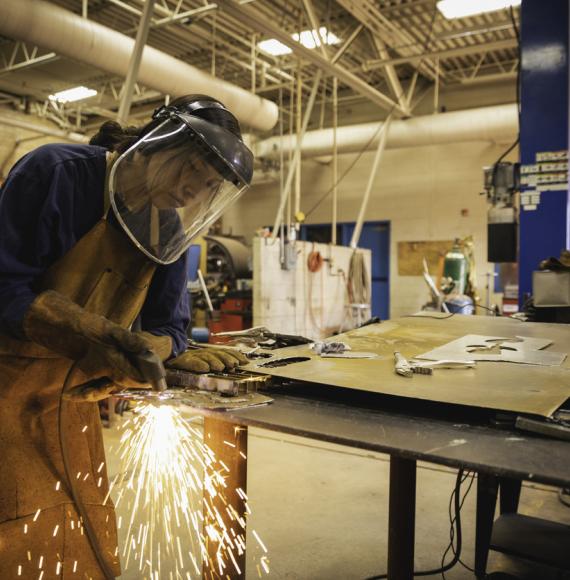 Young woman welding