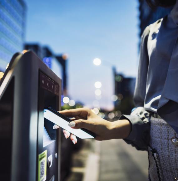 Woman paying for parking on her phone