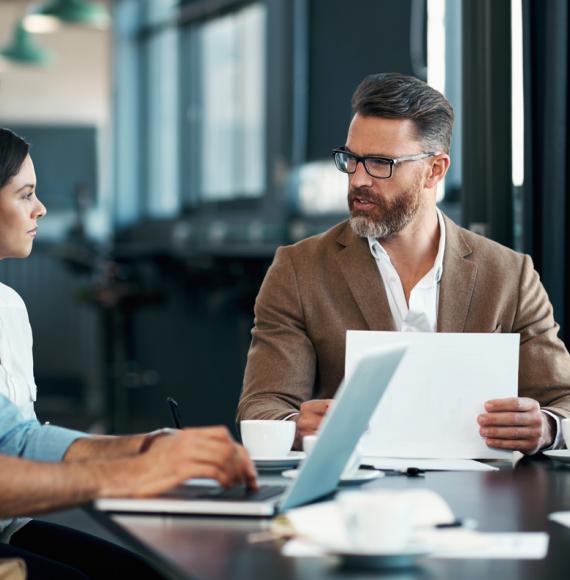 Man with beard talking with colleagues