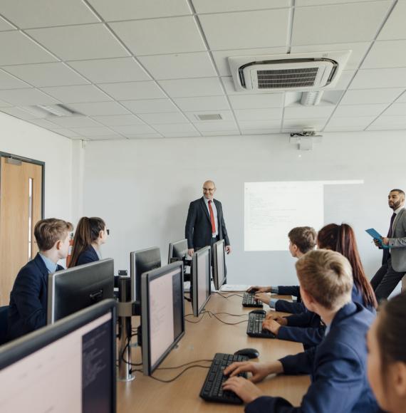 Pupils sat working on computers in a classroom