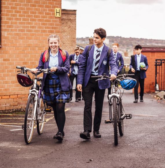Students pushing bikes