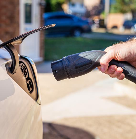 Man plugging an EV charger into his car