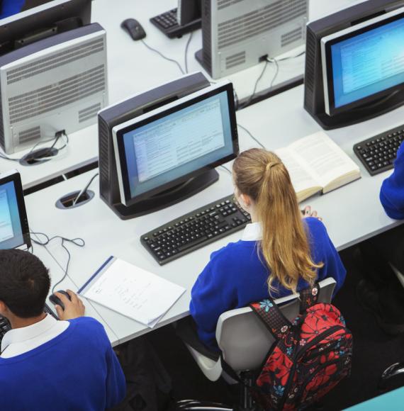 Pupils sat working on computers in a classroom
